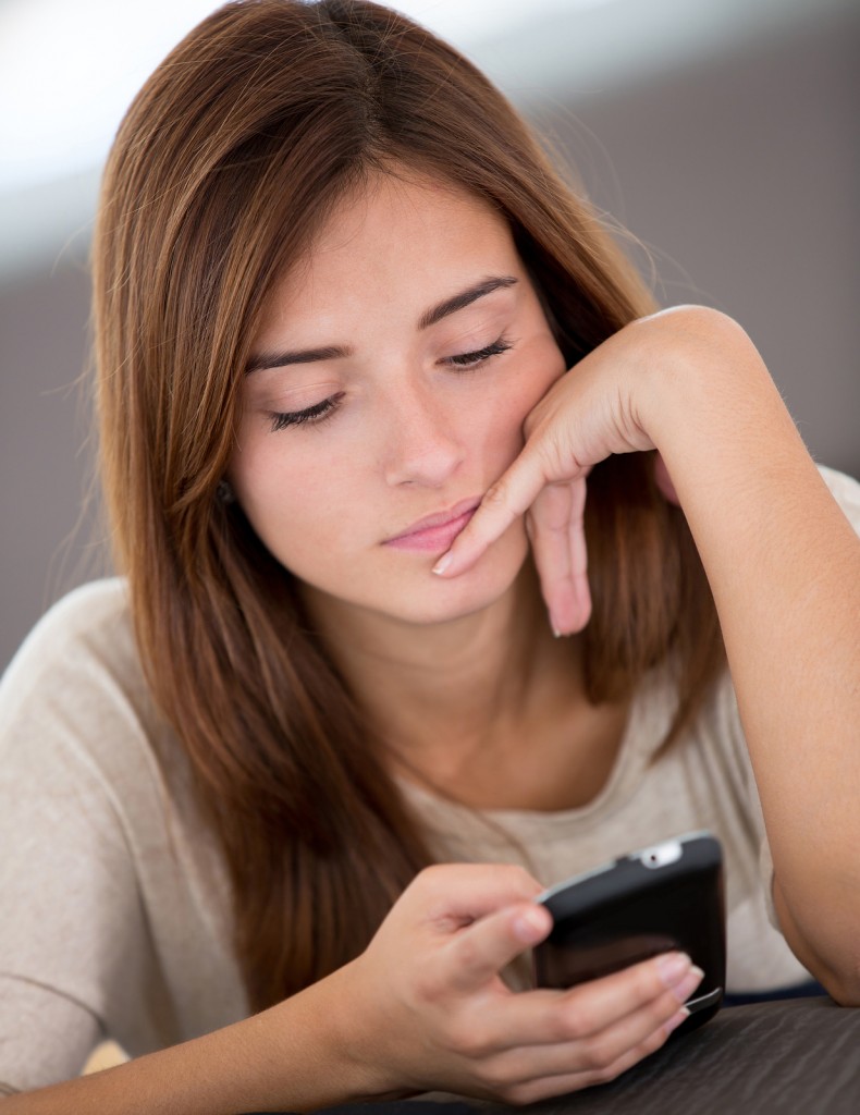 bigstock-Bored-woman-texting-on-her-mob-44747404